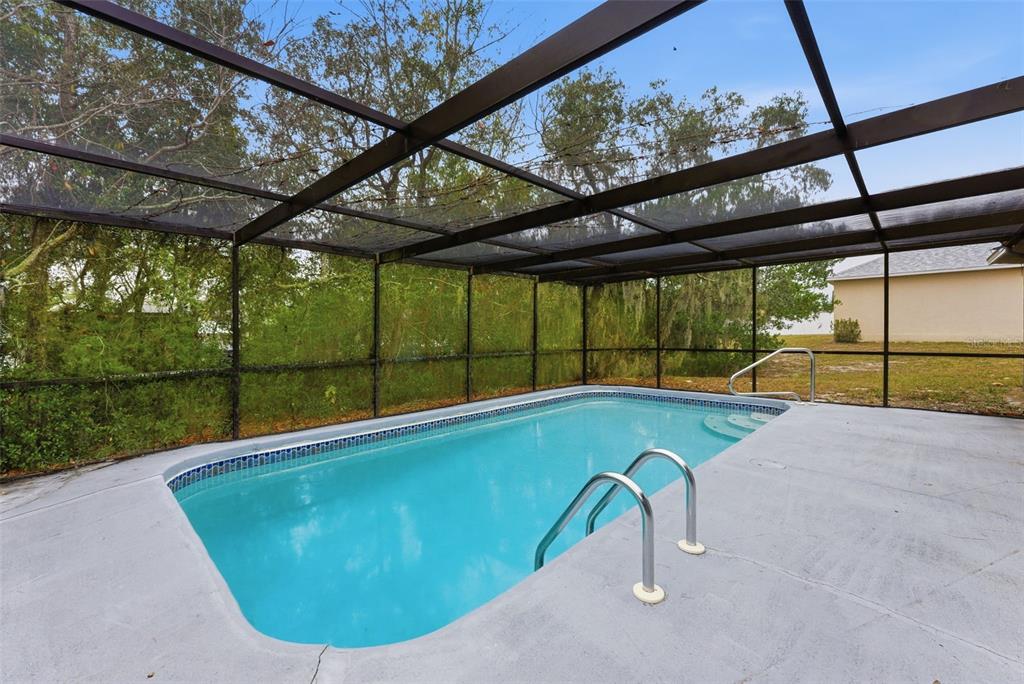 6211 Lorraine Lane Spring Hill, FL 34608 - Photo 2 of 28 a view of a swimming pool with a porch