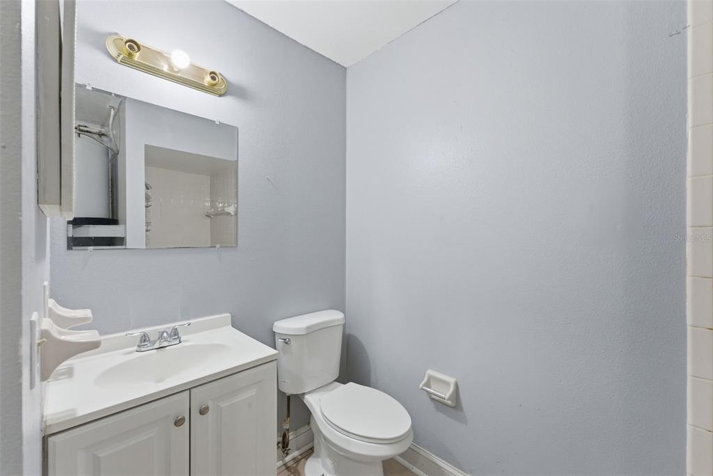 6211 Lorraine Lane Spring Hill, FL 34608 - Photo 22 of 28 a white toilet sitting next to a bathroom sink