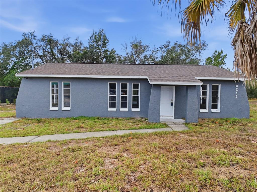 6211 Lorraine Lane Spring Hill, FL 34608 - Photo 4 of 28 a front view of a house with garden