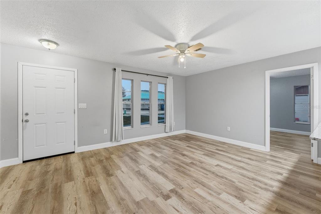 6211 Lorraine Lane Spring Hill, FL 34608 - Photo 5 of 28 wooden floor in an empty room with a window