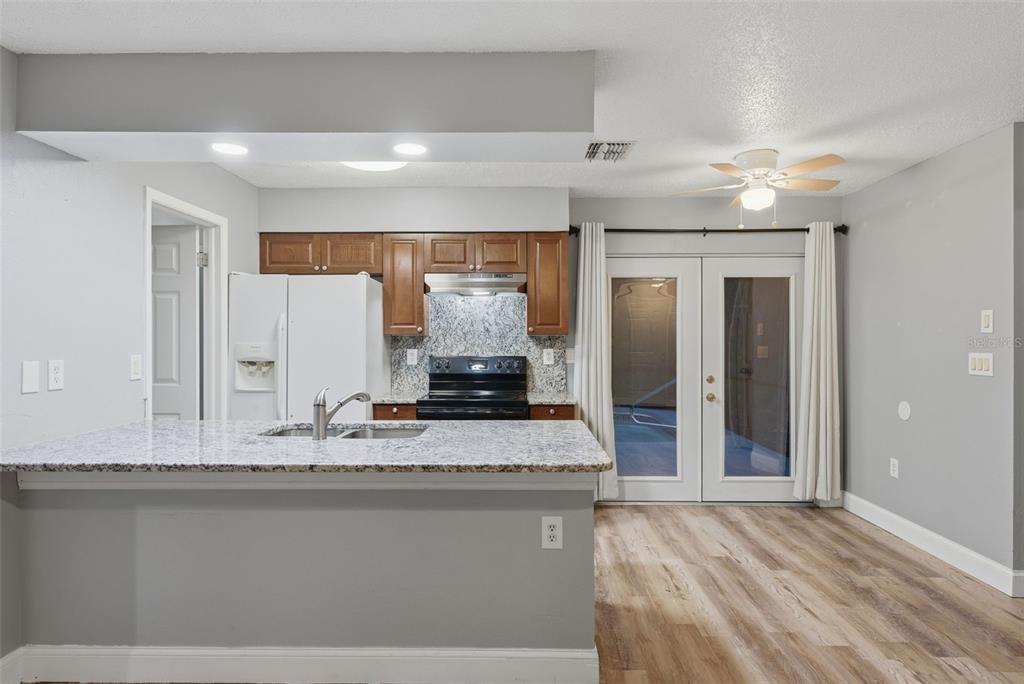 6211 Lorraine Lane Spring Hill, FL 34608 - Photo 10 of 28 a bathroom with a granite countertop sink and a mirror