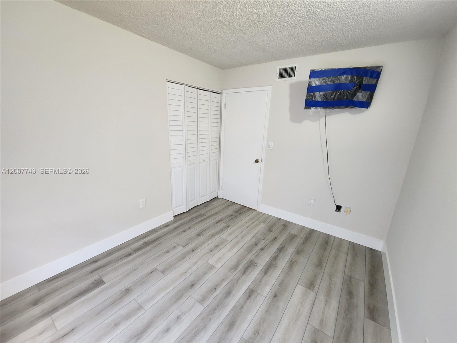 15250 Southwest 80th Street, Unit 4 Miami, FL 33193 - Photo 12 of 18 a view of an empty room with a window