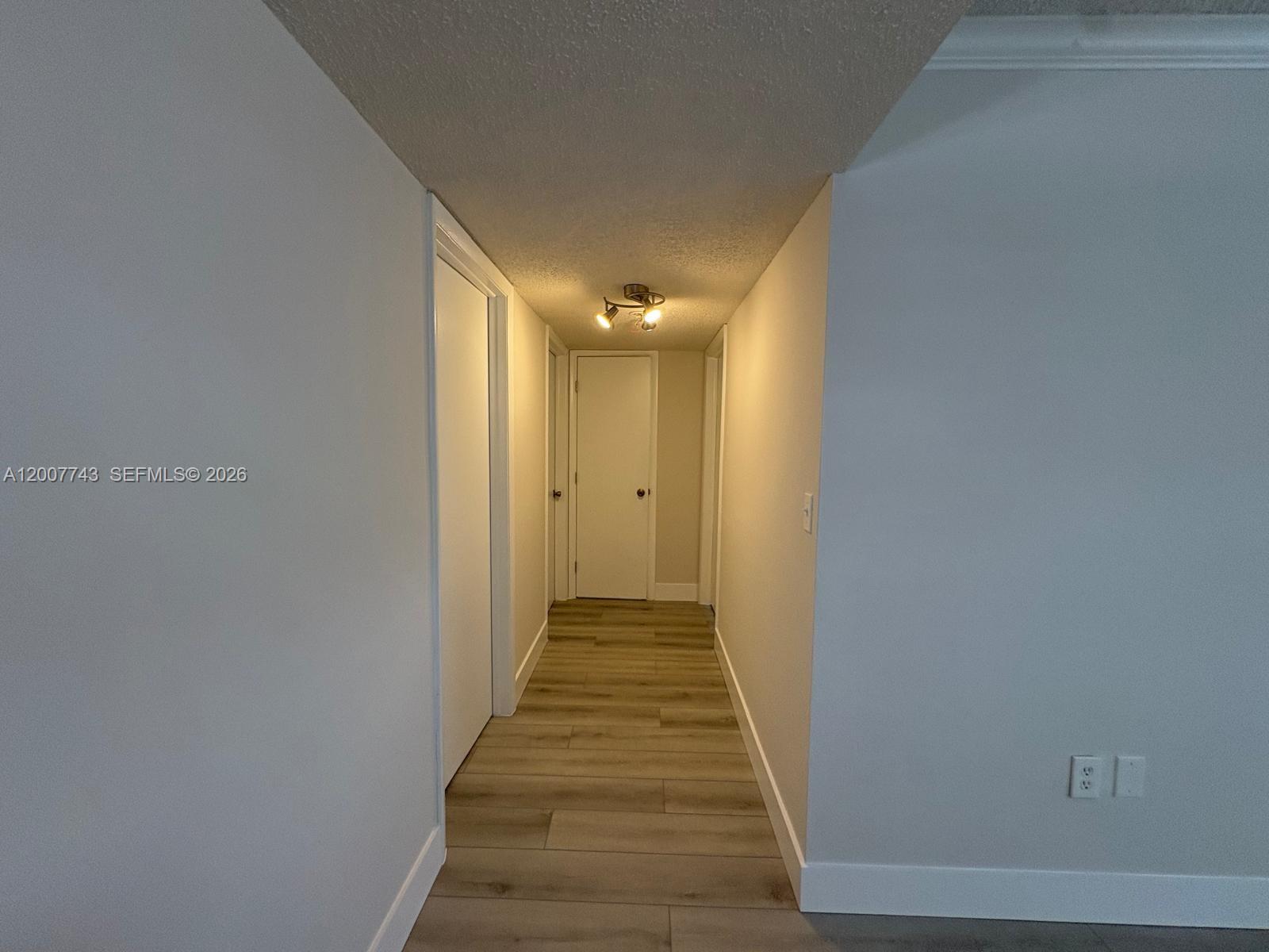 15250 Southwest 80th Street, Unit 4 Miami, FL 33193 - Photo 13 of 18 a view of a hallway with wooden floor