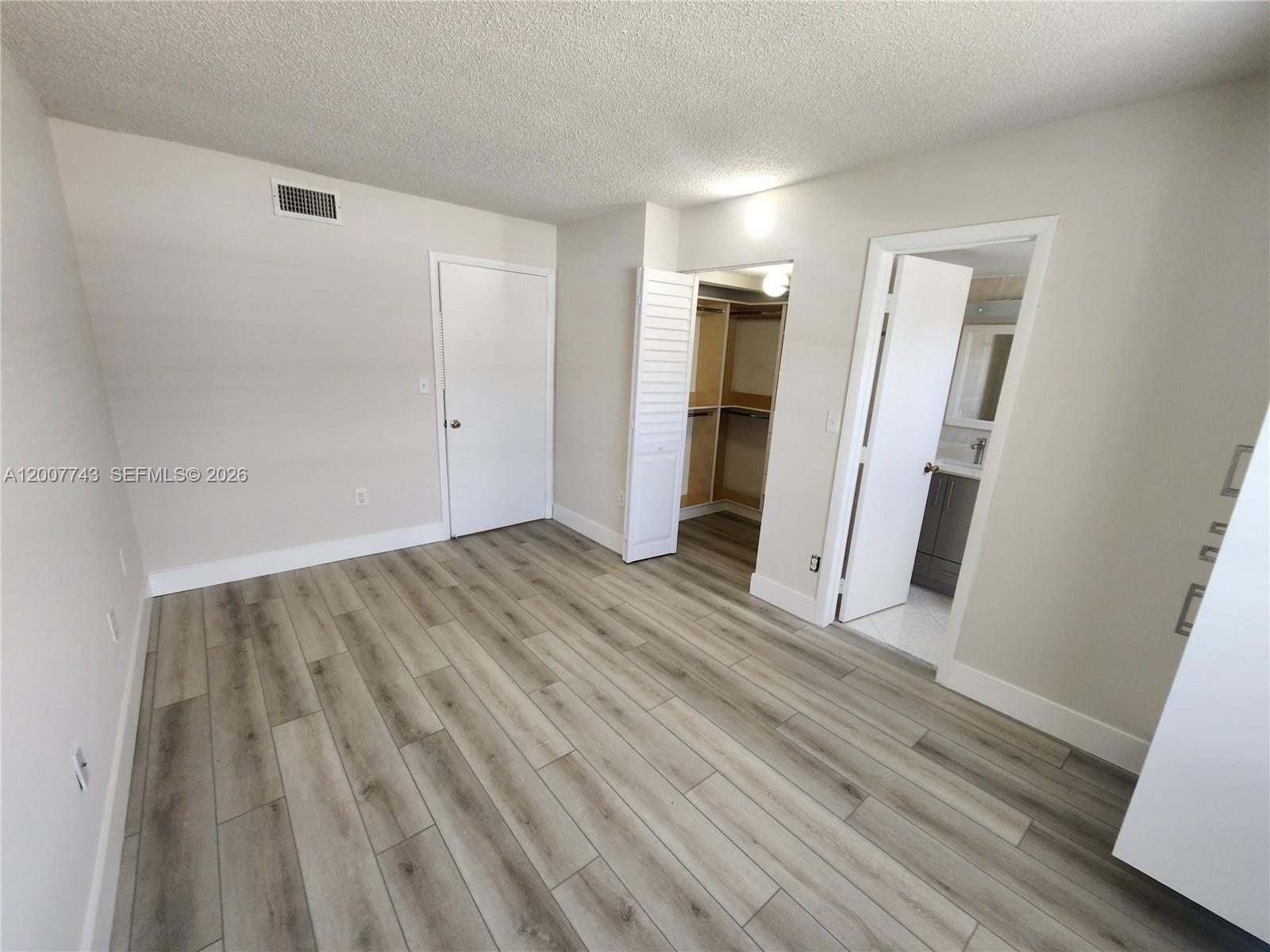 15250 Southwest 80th Street, Unit 4 Miami, FL 33193 - Photo 7 of 18 a view of a room with wooden floor and staircase