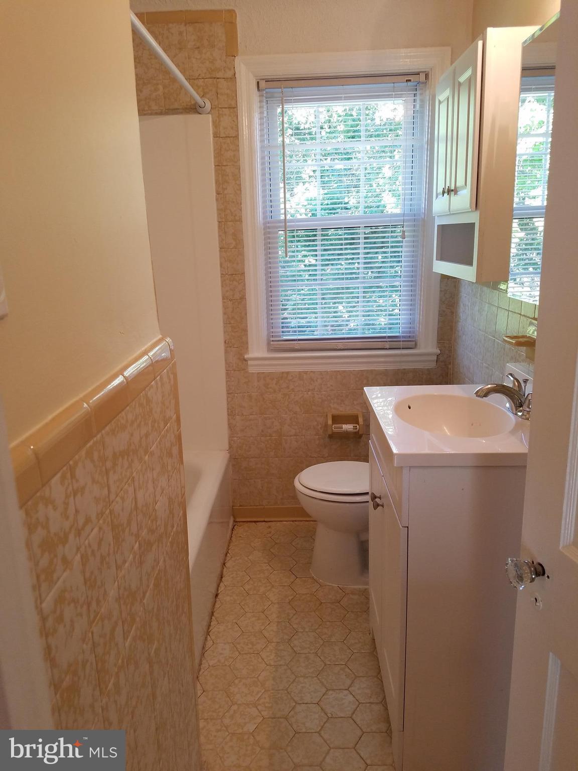 5561 Ashbourne Road Halethorpe, MD 21227 - Photo 11 of 21 a bathroom with a sink a toilet and tub