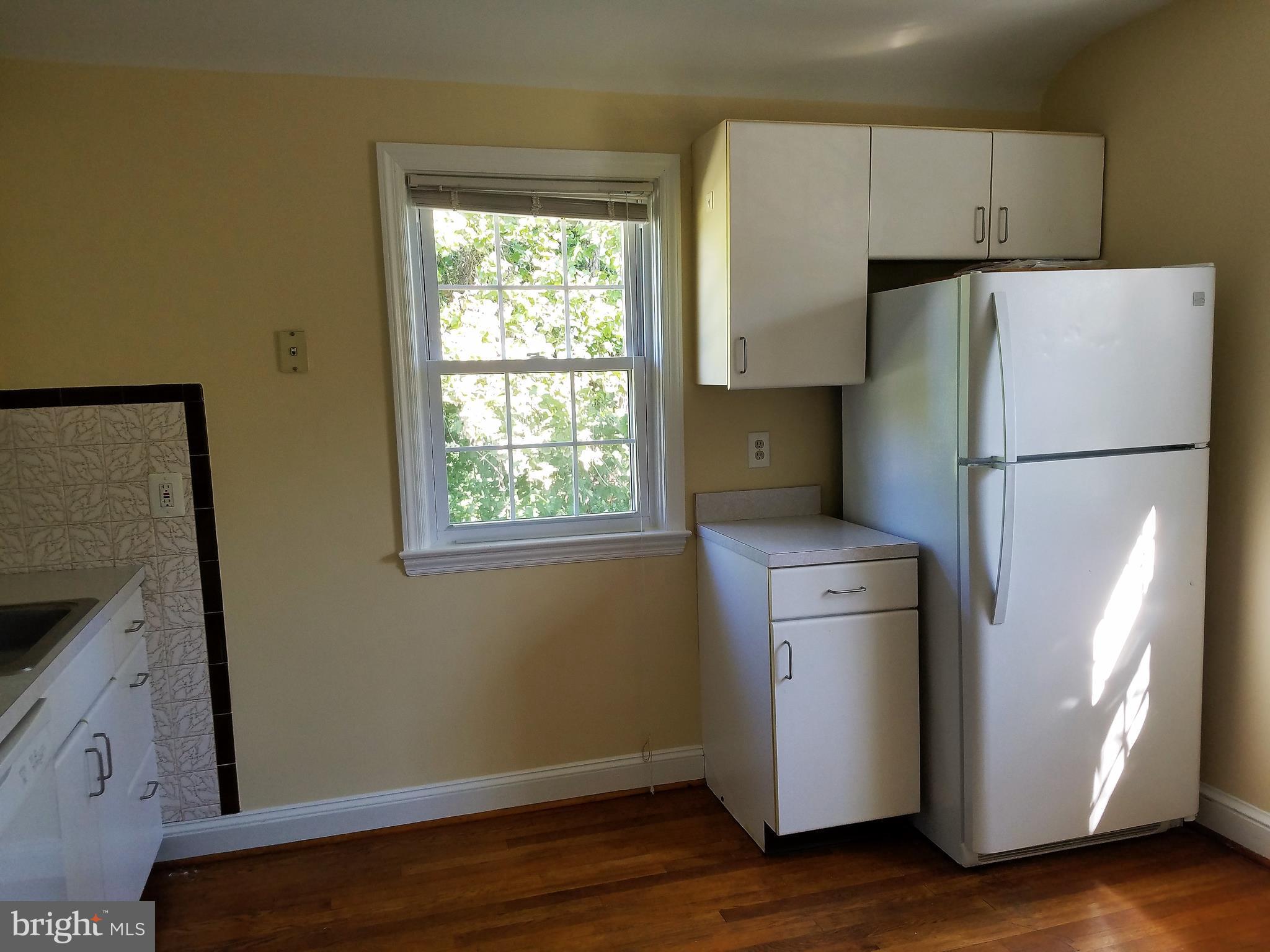 5561 Ashbourne Road Halethorpe, MD 21227 - Photo 14 of 21 a white refrigerator freezer sitting in a kitchen