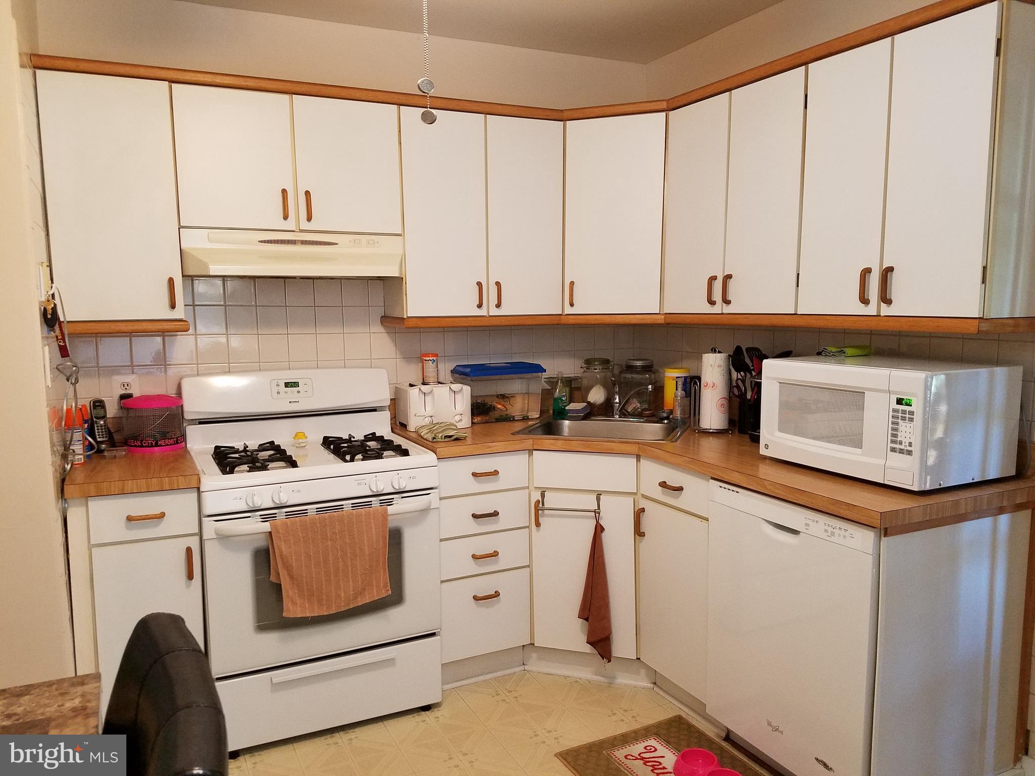 5561 Ashbourne Road Halethorpe, MD 21227 - Photo 4 of 21 a kitchen with a stove and a white refrigerator