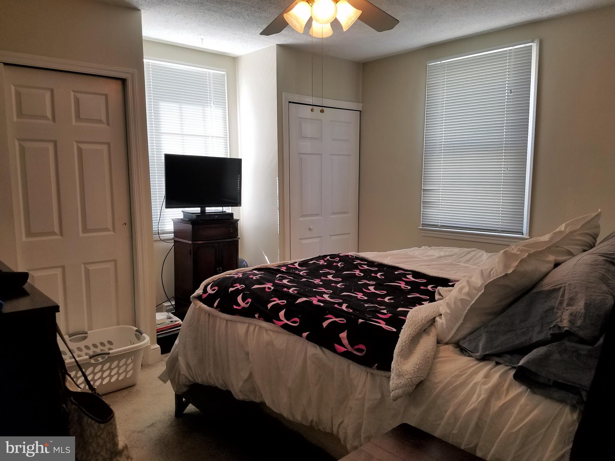 5561 Ashbourne Road Halethorpe, MD 21227 - Photo 8 of 21 a bedroom with a bed and a flat tv screen on dresser
