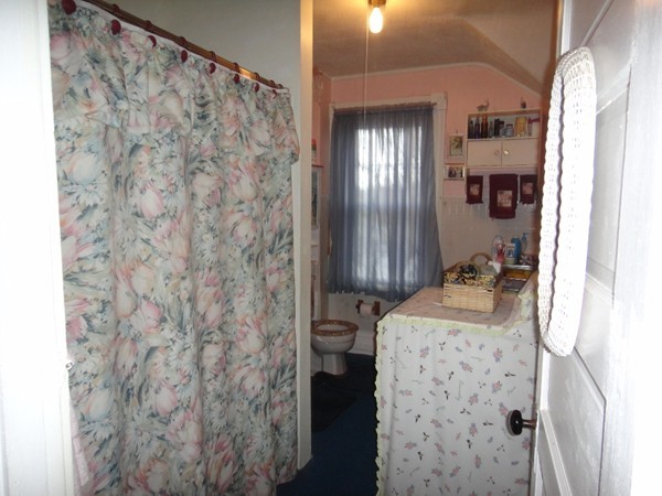 89 Spring Street Fairhaven, MA 02719 - Photo 12 of 27 a bathroom with a granite countertop sink a toilet and shower curtain