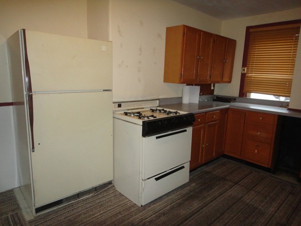 89 Spring Street Fairhaven, MA 02719 - Photo 26 of 27 a kitchen with stainless steel appliances granite countertop a refrigerator a sink dishwasher a stove with wooden cabinets