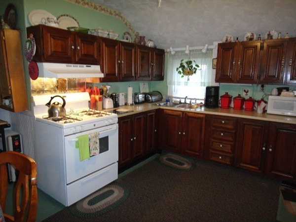 89 Spring Street Fairhaven, MA 02719 - Photo 6 of 27 a kitchen with a sink a stove and cabinets