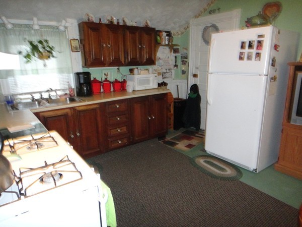 89 Spring Street Fairhaven, MA 02719 - Photo 7 of 27 a kitchen with a refrigerator sink and a stove