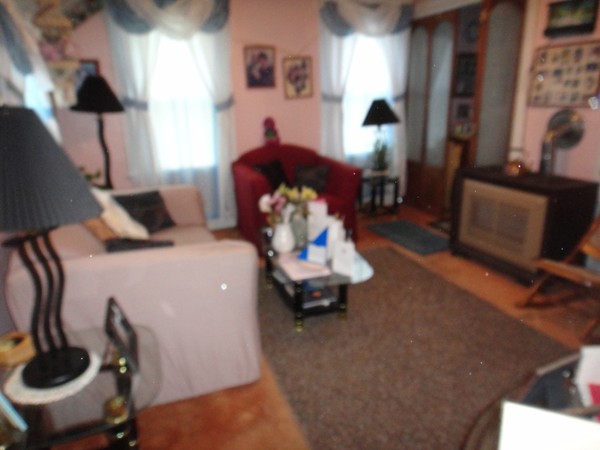 89 Spring Street Fairhaven, MA 02719 - Photo 8 of 27 a bedroom with a bed and a chandelier