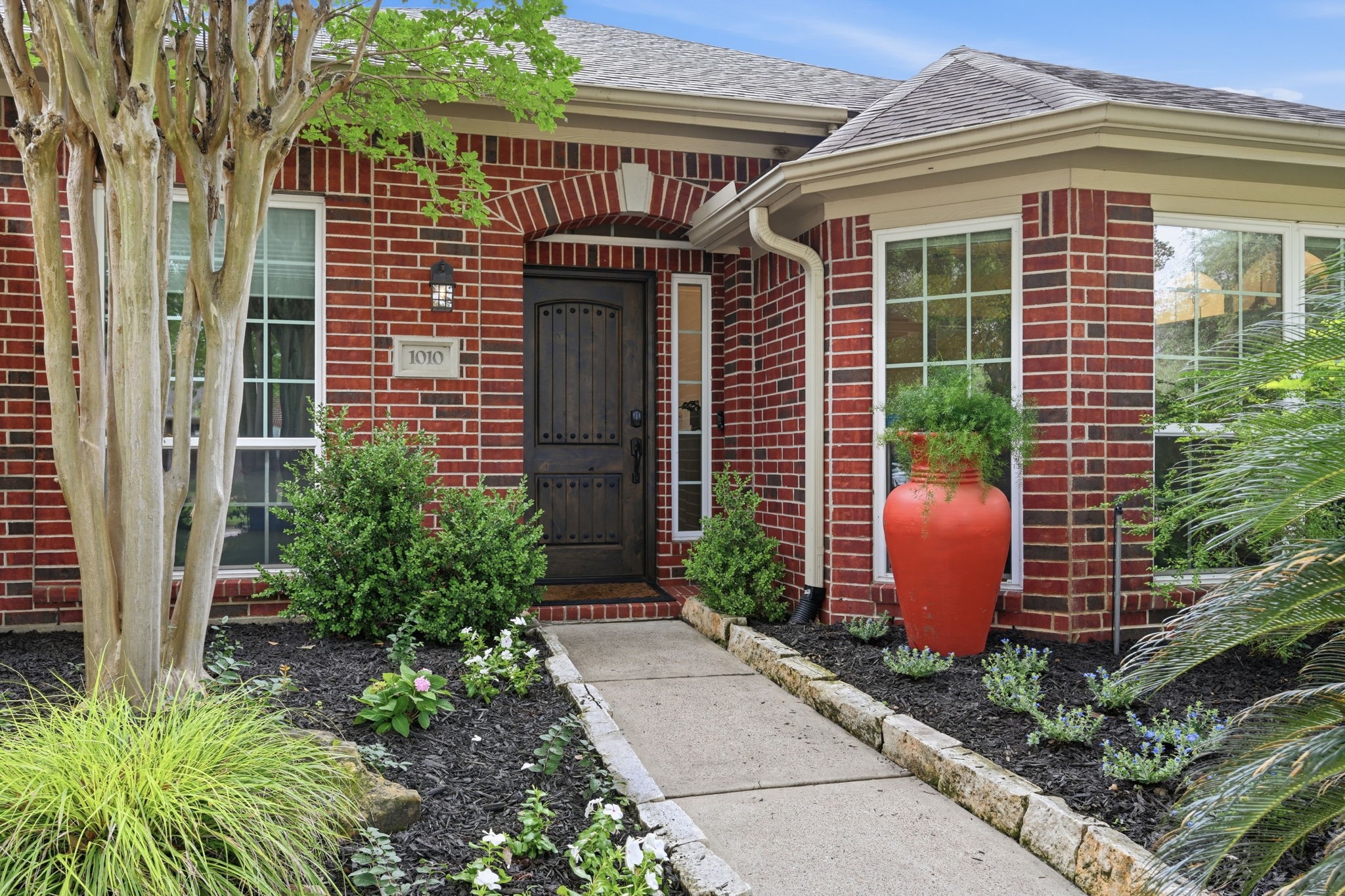 1010 Bringewood Chase Drive Spring, TX 77379 - Photo 3 of 49 Newer solid wood front door with sidelight. Austin stone lines the walkway.