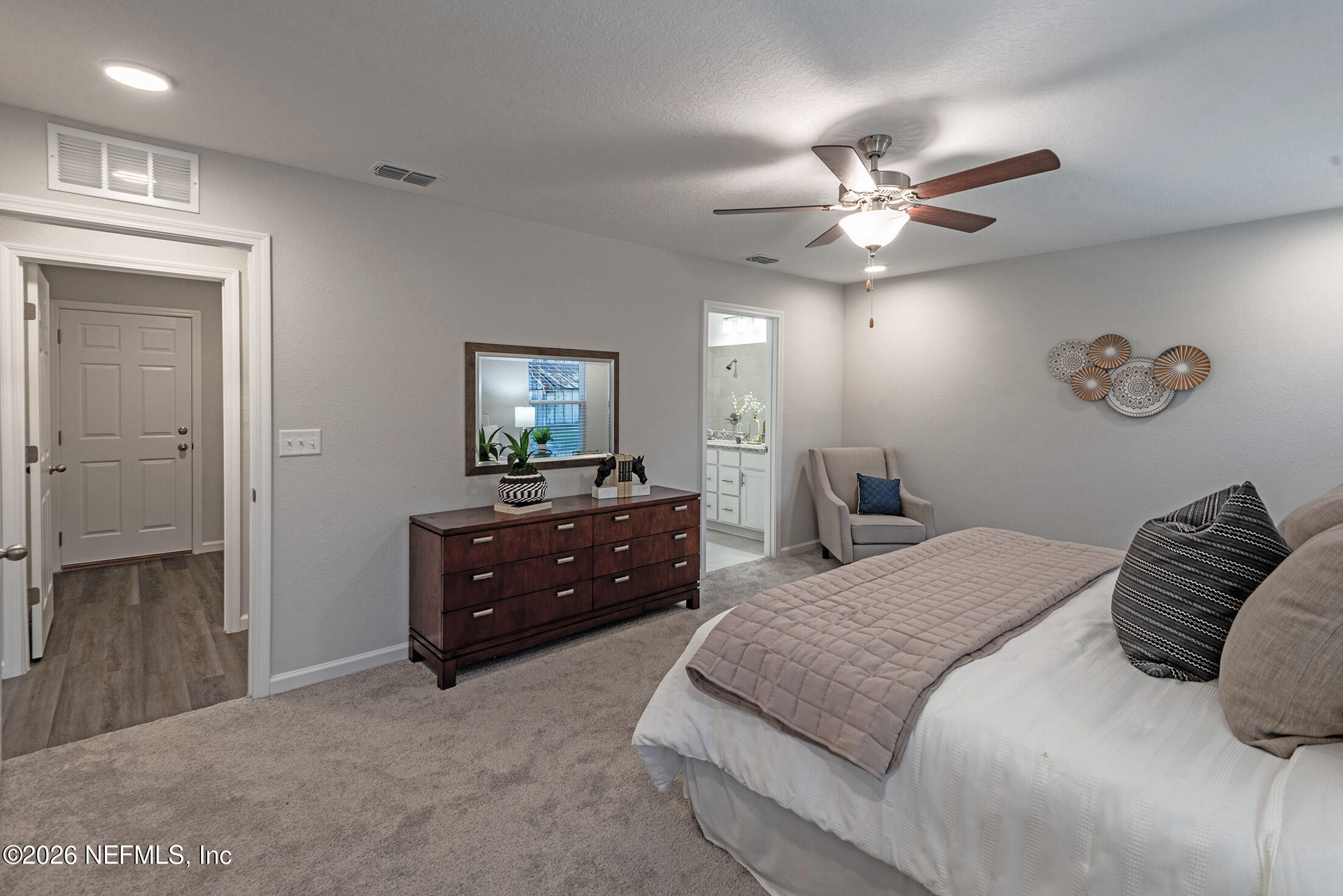 13748 Coman Road Jacksonville, FL 32218 - Photo 18 of 34 a bedroom with a bed and a chandelier