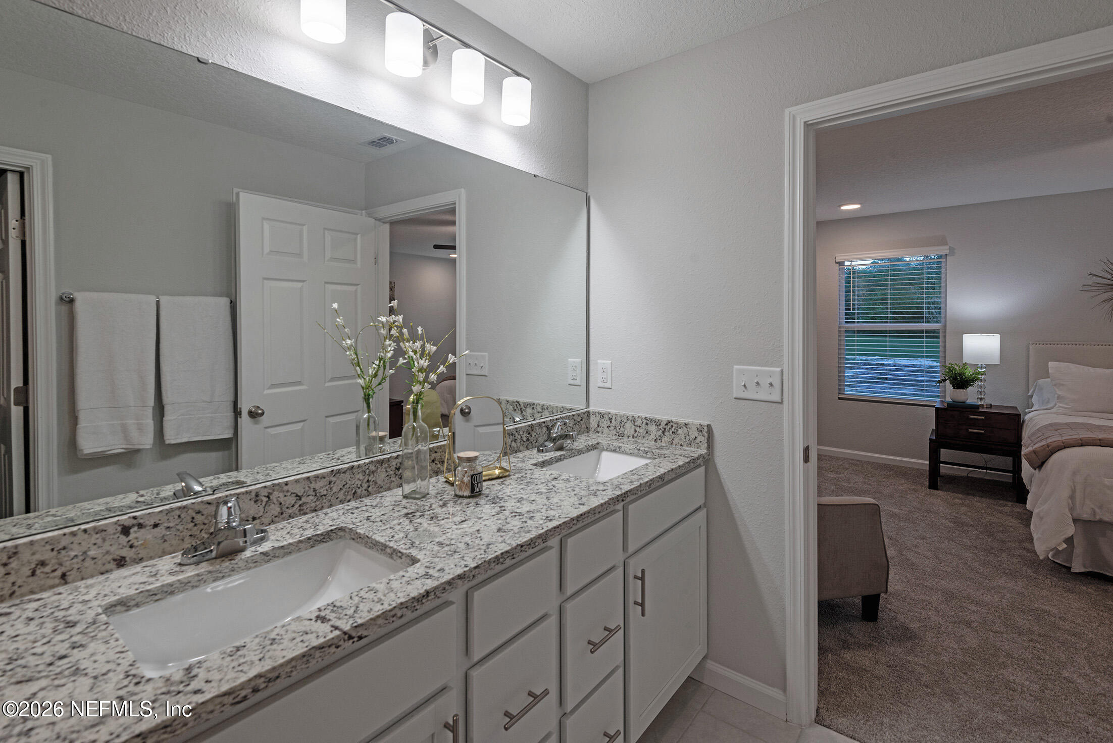 13748 Coman Road Jacksonville, FL 32218 - Photo 21 of 34 a bathroom with a granite countertop sink and a mirror