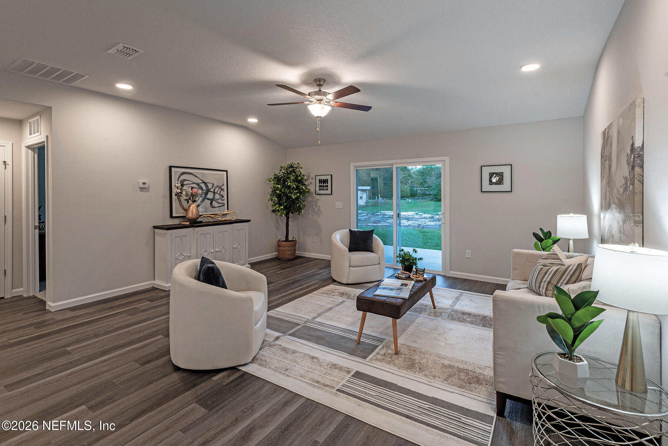 13748 Coman Road Jacksonville, FL 32218 - Photo 23 of 34 a living room with furniture and a potted plant