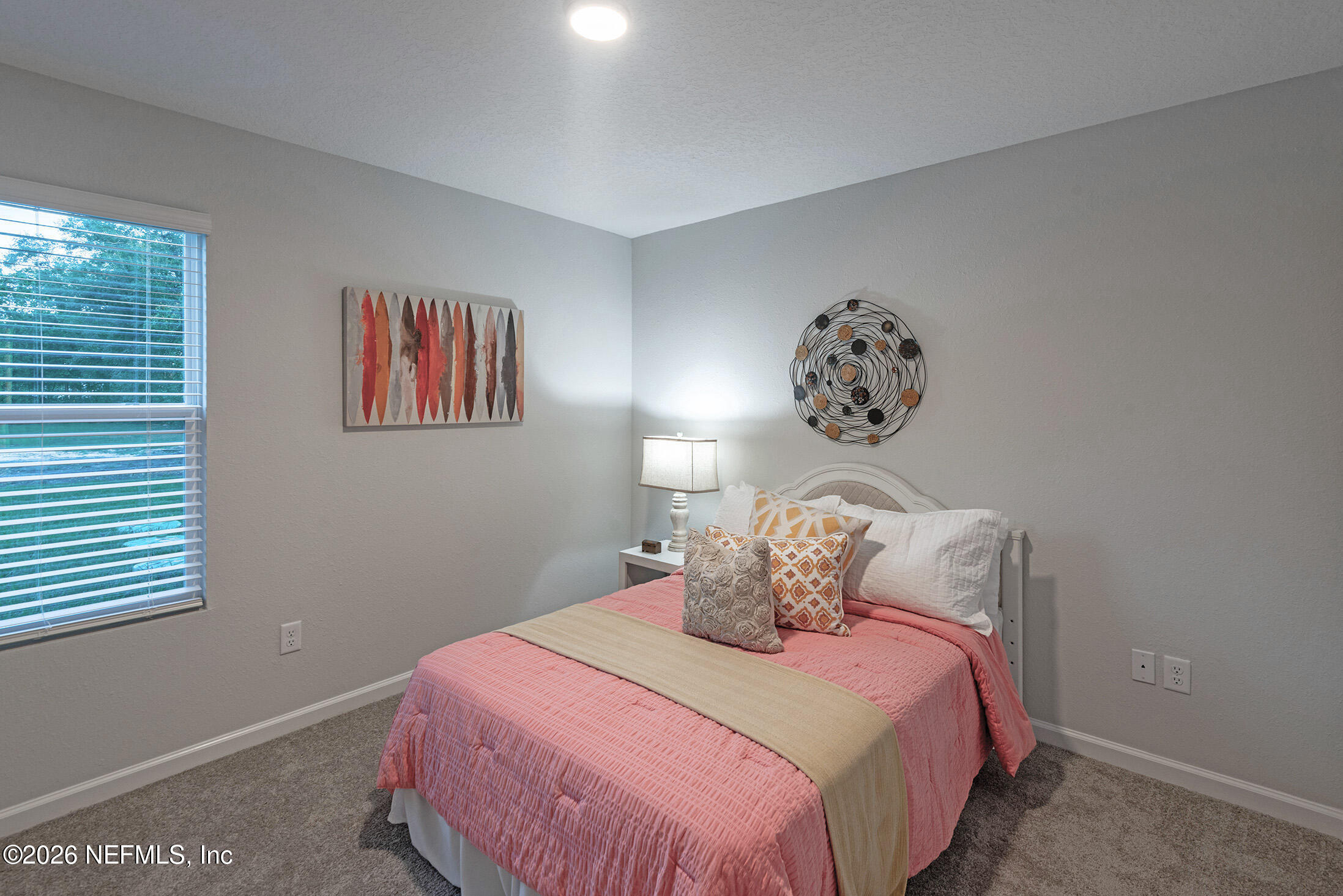 13748 Coman Road Jacksonville, FL 32218 - Photo 27 of 34 a bedroom with a bed and a painting on the wall
