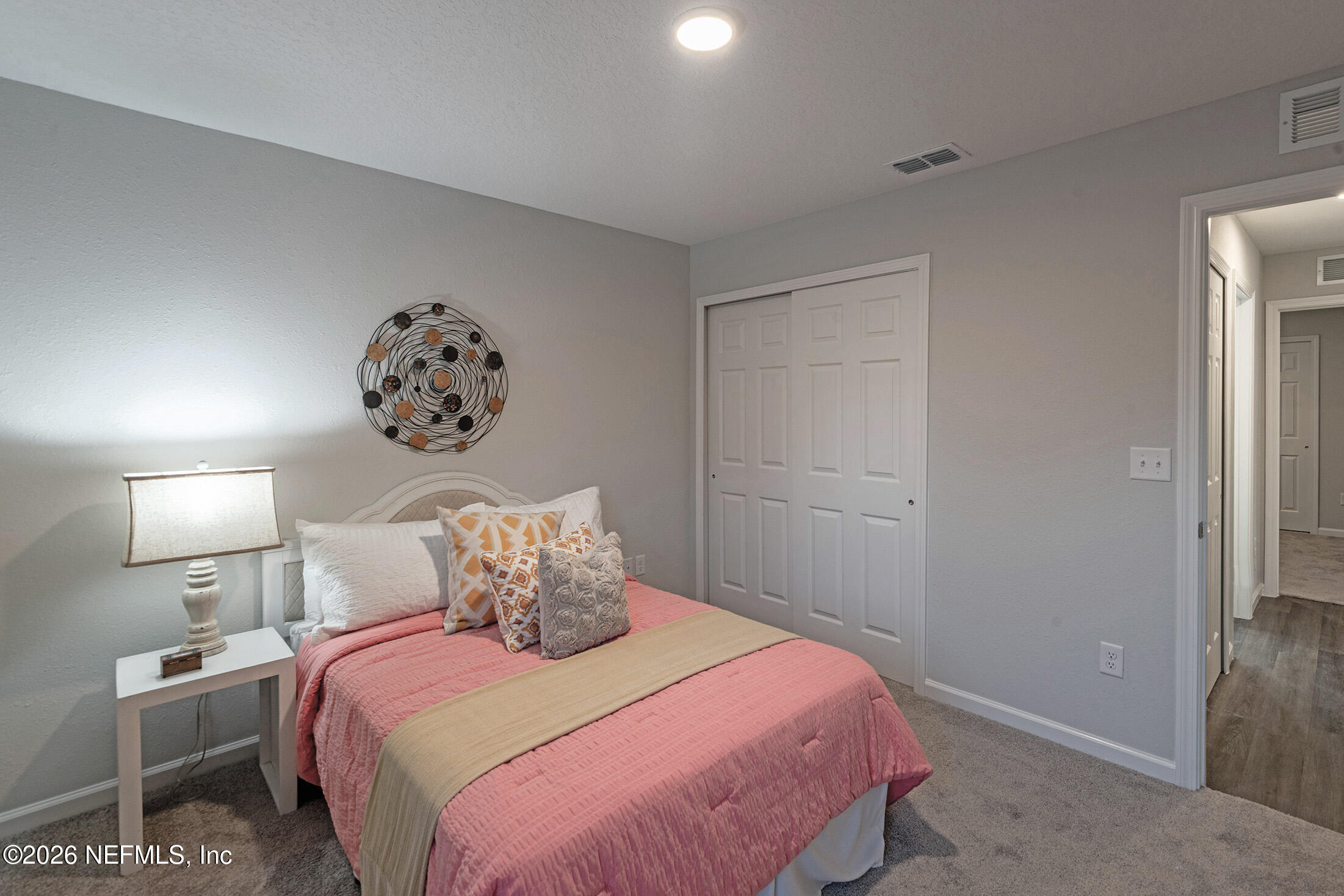 13748 Coman Road Jacksonville, FL 32218 - Photo 28 of 34 a bedroom with a bed and a lamp on table