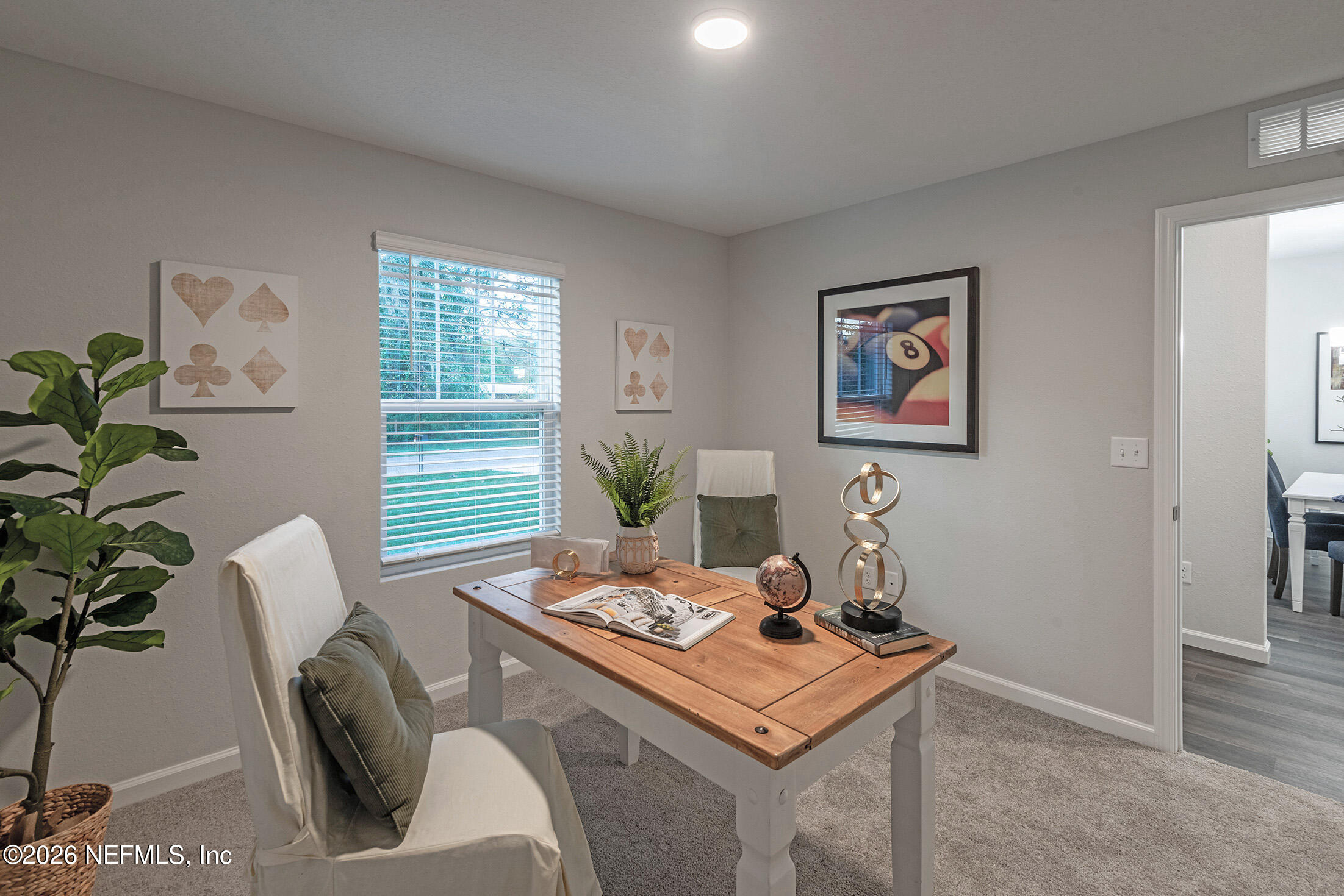 13748 Coman Road Jacksonville, FL 32218 - Photo 8 of 34 a view of a workspace with furniture and a potted plant
