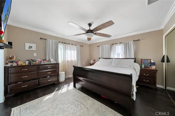a spacious bedroom with a bed and a dresser in it