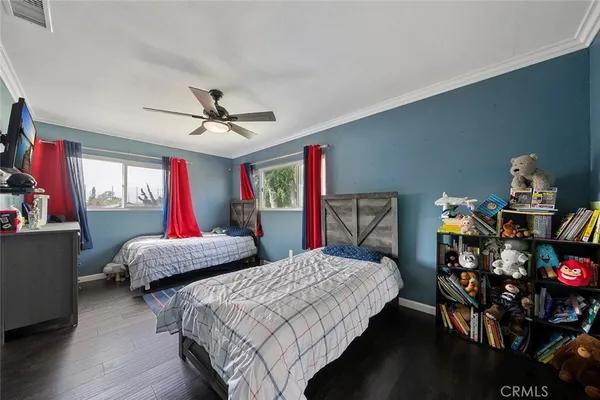 a bedroom with two beds and a chandelier