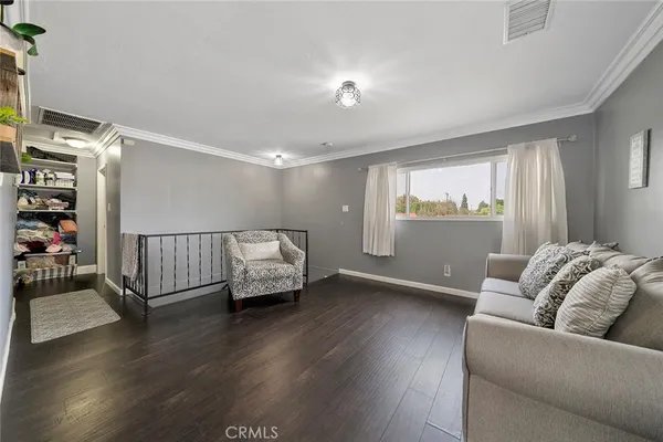 a living room with furniture window and wooden floor