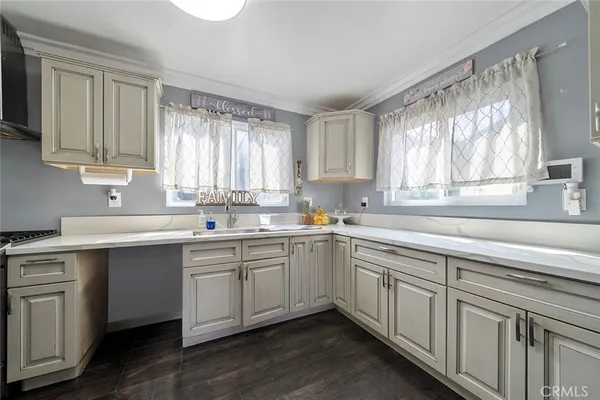 a kitchen with sink cabinets and window