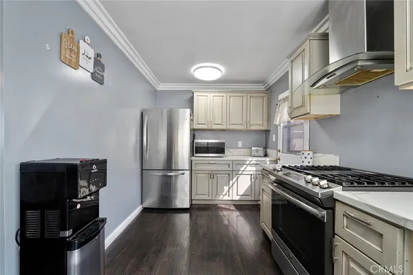 a kitchen with a stove a refrigerator and a sink
