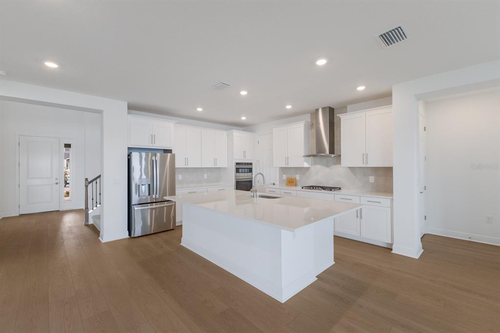 4611 Sweet Retreat Run Lakewood Ranch, FL 34211 - Photo 15 of 37 a large white kitchen with a sink and refrigerator