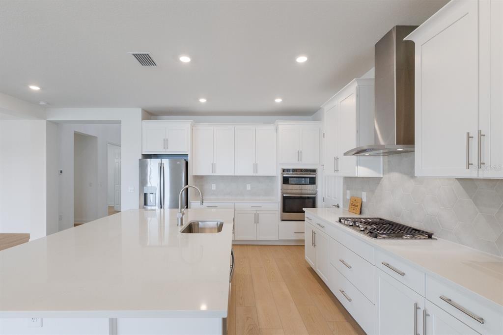 4611 Sweet Retreat Run Lakewood Ranch, FL 34211 - Photo 16 of 37 a large white kitchen with stainless steel appliances