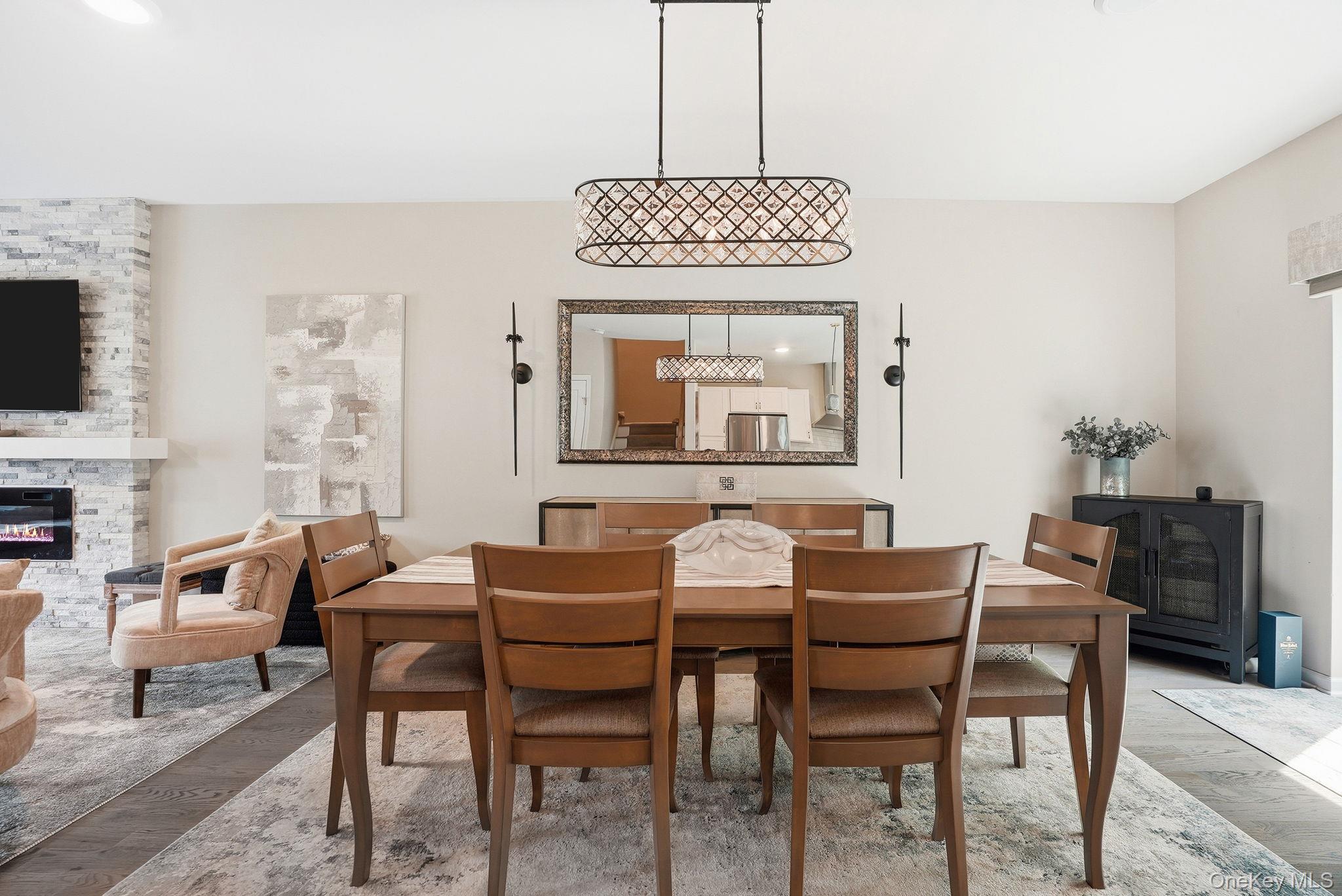 8 Muscoot River Road Granite Springs, NY 10527 - Photo 11 of 40 Open-concept dining area featuring wood-finish flooring, an ornate linear chandelier, and neutral wall tones