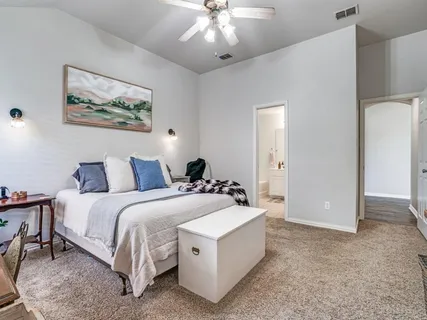 a spacious bedroom with a bed and a couch