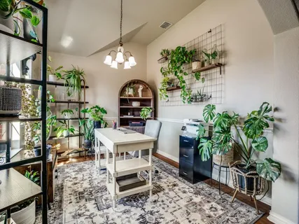 a living room with furniture a potted plant and a chandelier