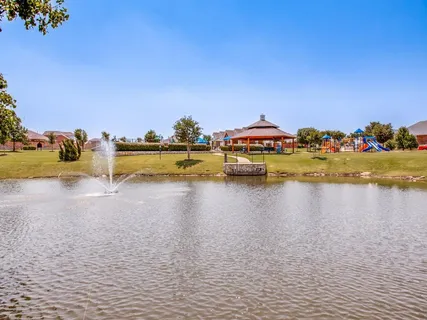 a swimming pool covered with buildings in the background