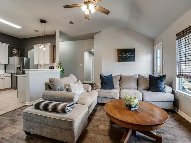 a living room with furniture and a chandelier