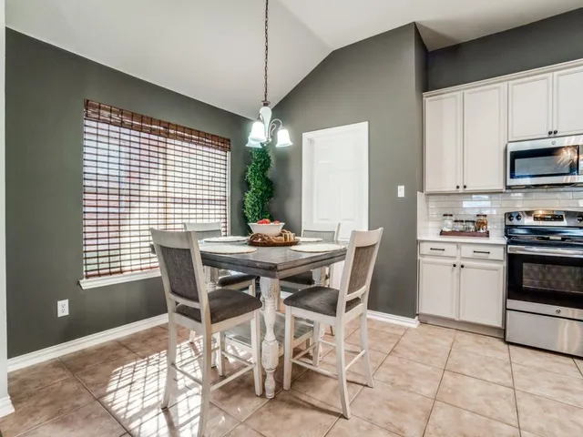 a view of a dining room with furniture and chandelier