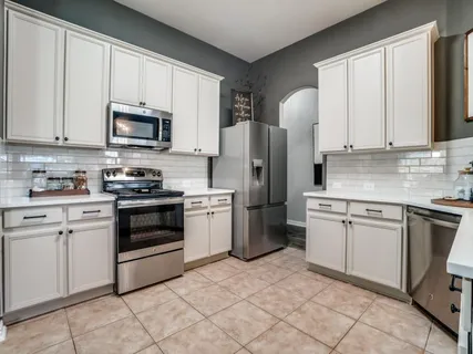 a kitchen with a sink cabinets and window