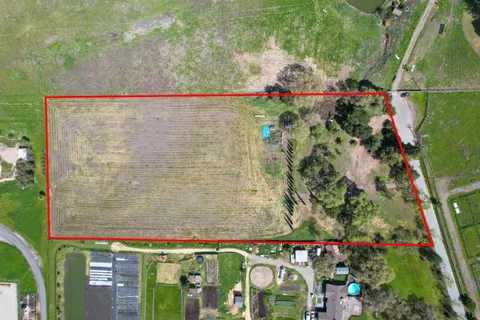 an aerial view of a houses with a yard