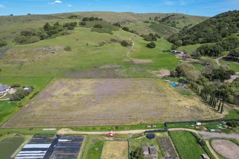 an aerial view of a residential houses with outdoor space