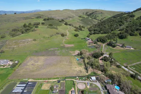 an aerial view of mountain with residential house and lake view
