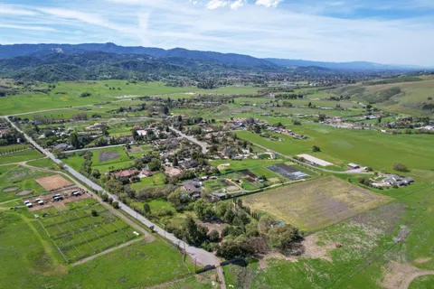 a view of a lush green hillside and houses