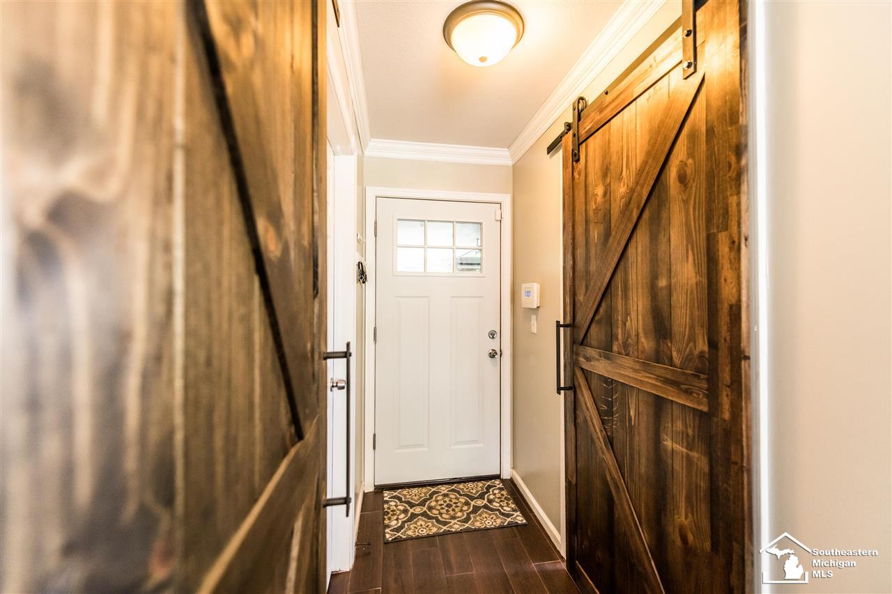 26671 Bell Road New Boston, MI 48164 - Photo 23 of 55 Beautiful Wood Doors leading into Basement & Laundry. Attached Garage Door Entry