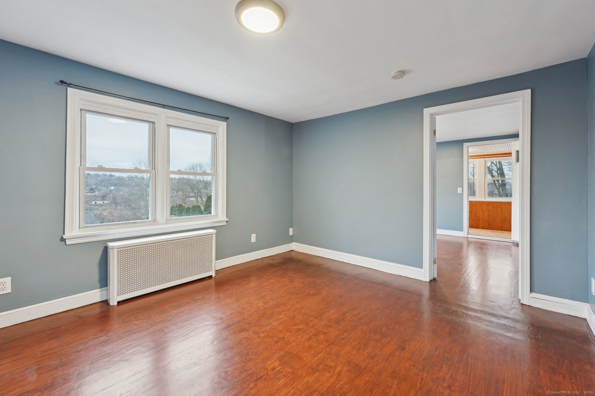 59 High Street Derby, CT 06418 - Photo 12 of 29 an empty room with wooden floor and windows