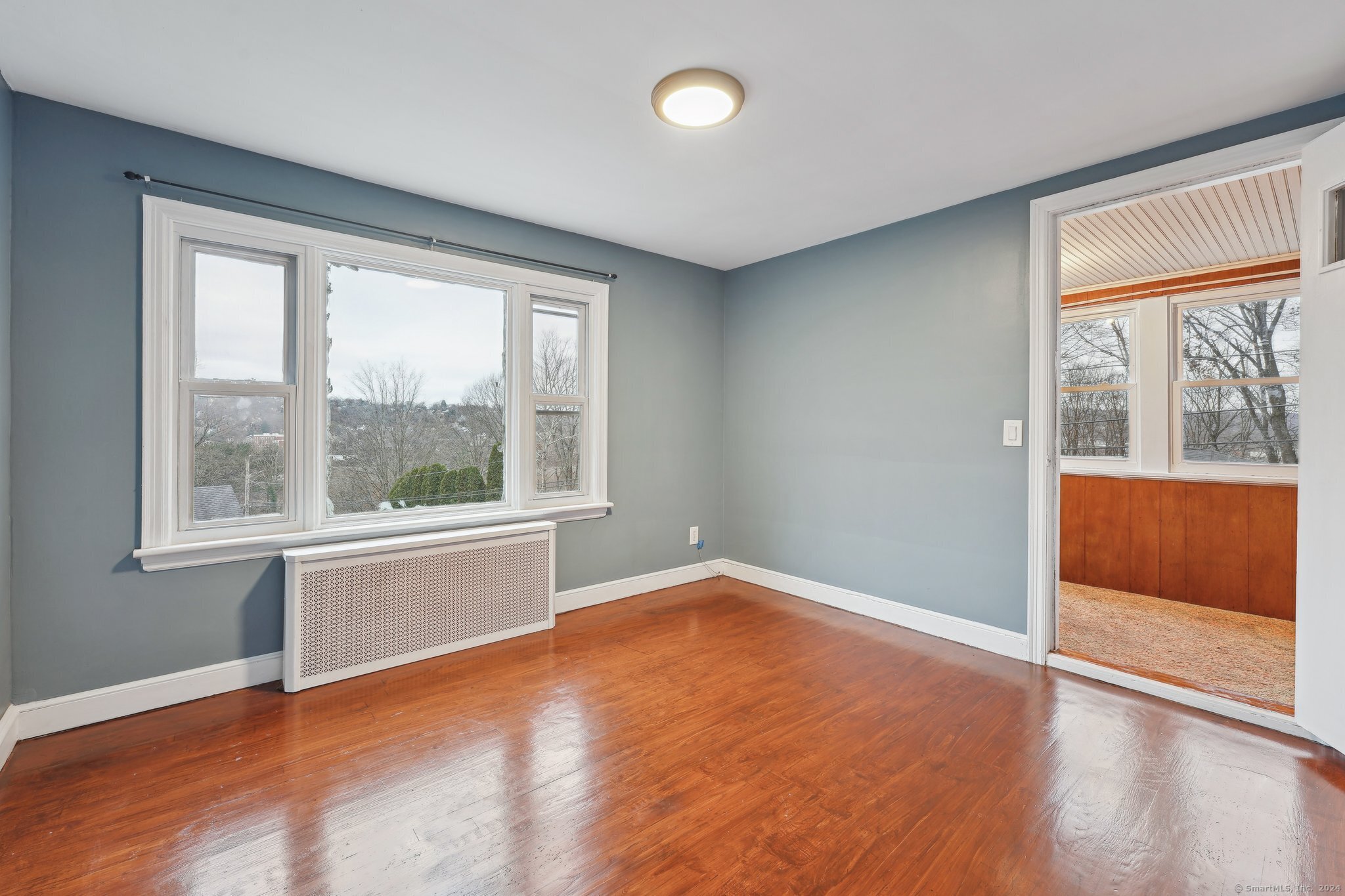 59 High Street Derby, CT 06418 - Photo 2 of 29 an empty room with wooden floor and windows