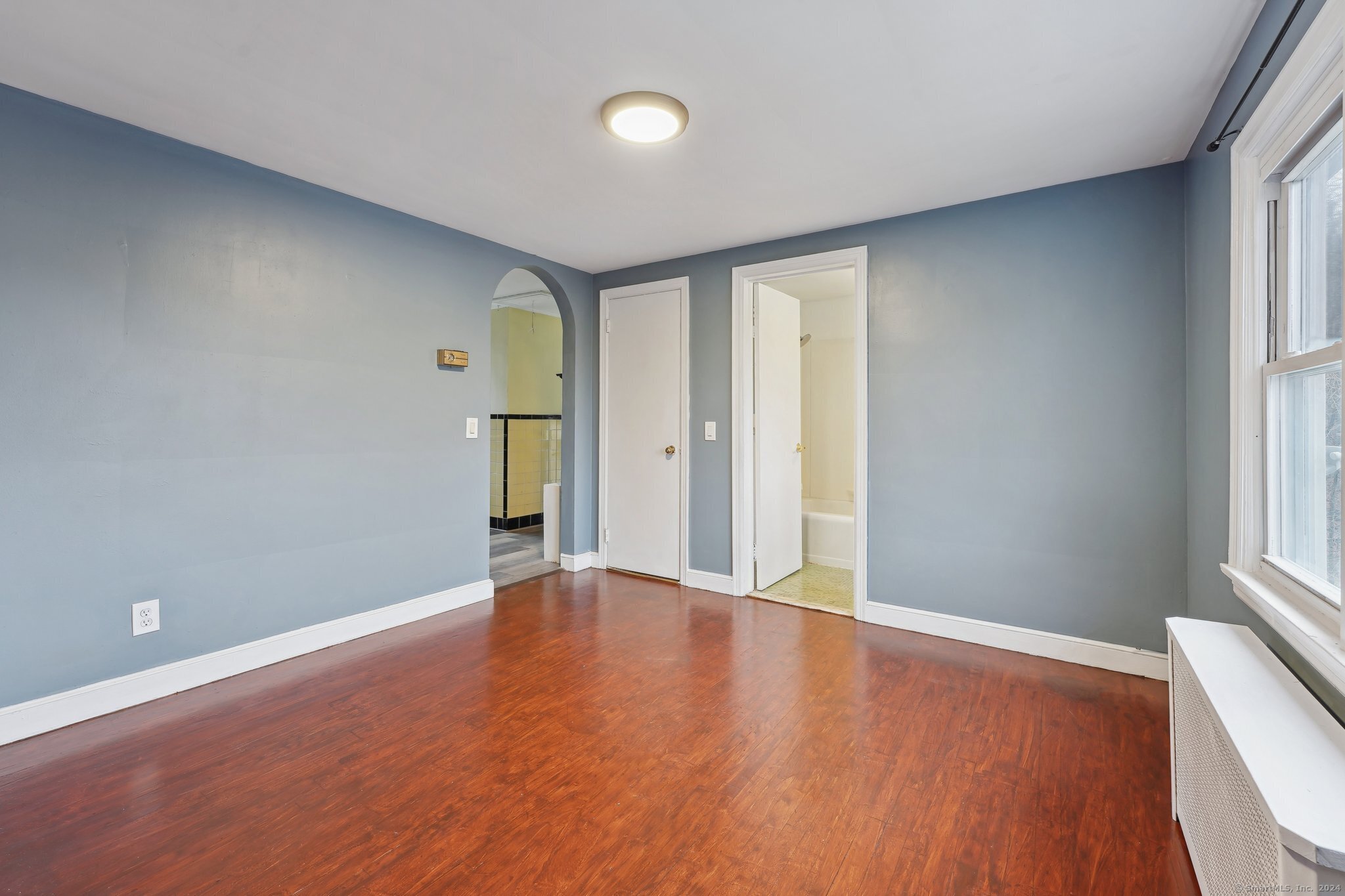59 High Street Derby, CT 06418 - Photo 4 of 29 an empty room with window and wooden floor