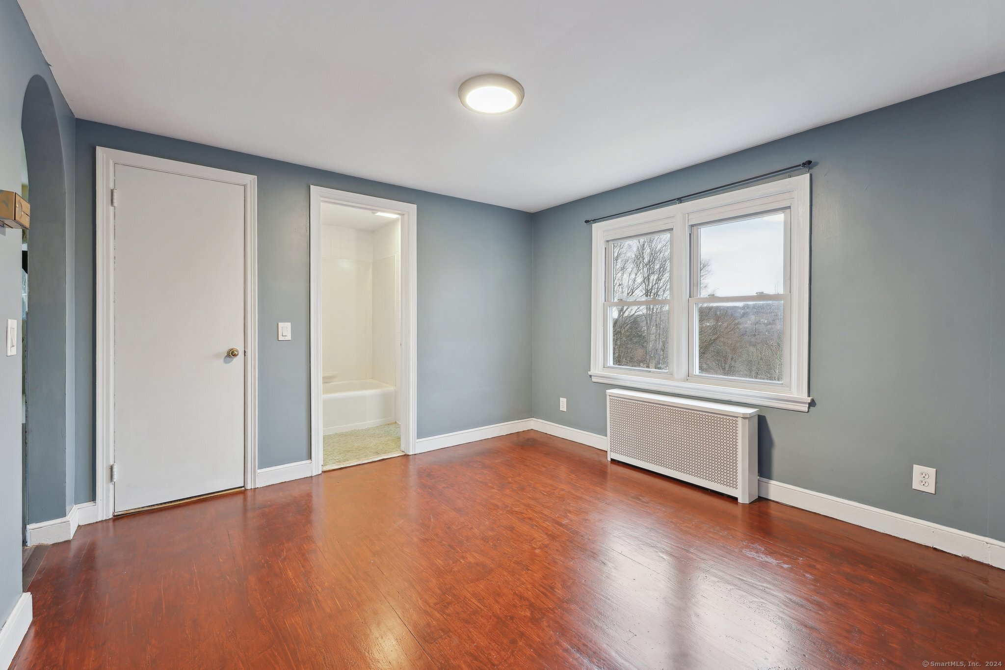 59 High Street Derby, CT 06418 - Photo 5 of 29 a view of an empty room with wooden floor and a window