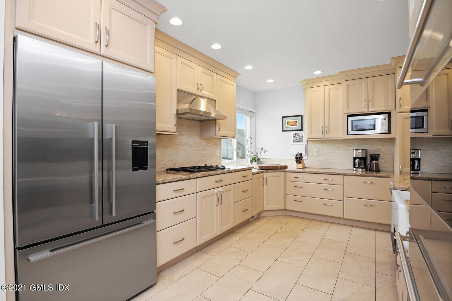 3 Whiffletree Way, Unit 3 Riverside, CT 06878 - Photo 3 of 24 a large kitchen with stainless steel appliances kitchen island granite countertop a refrigerator a sink a stove and white cabinets