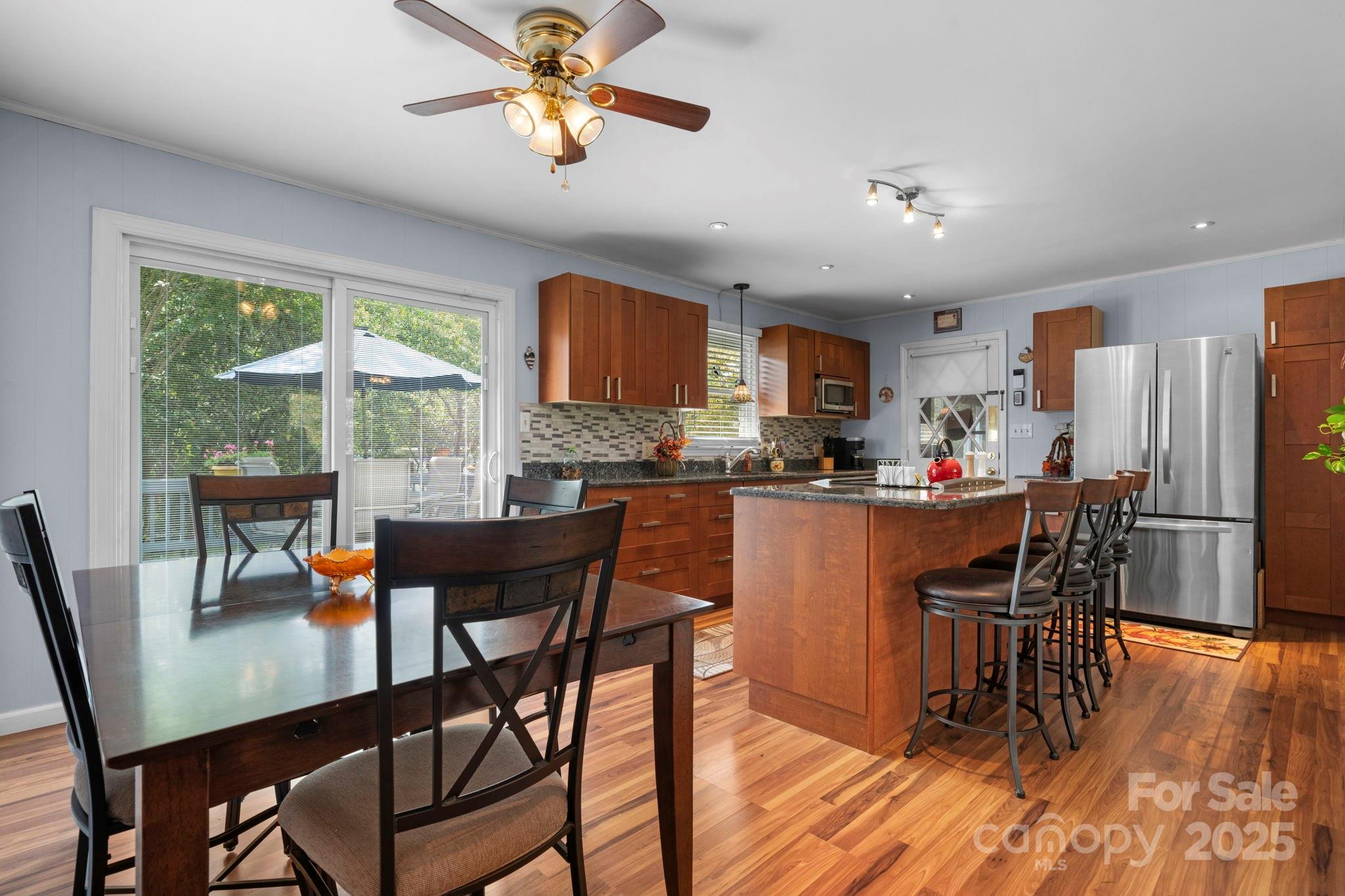 3651 Pea Ridge Road Morganton, NC 28655 - Photo 12 of 43 a kitchen with stainless steel appliances granite countertop a dining table chairs refrigerator and a sink