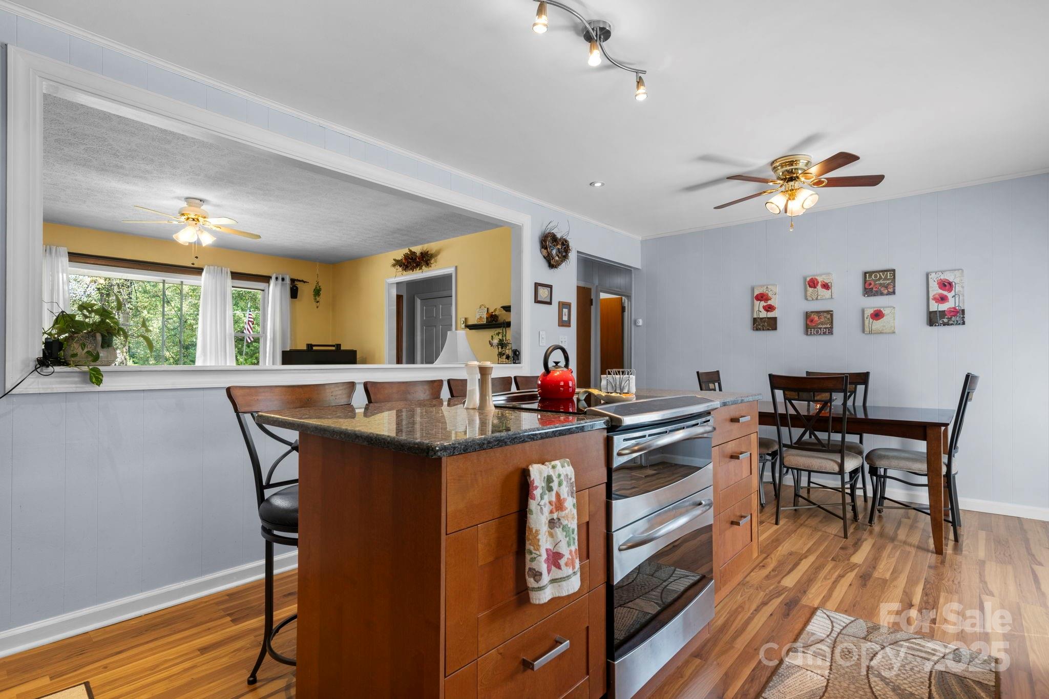 3651 Pea Ridge Road Morganton, NC 28655 - Photo 13 of 43 a view of a dining room with furniture window and wooden floor